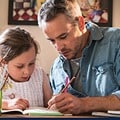 Father and daughter working on homework